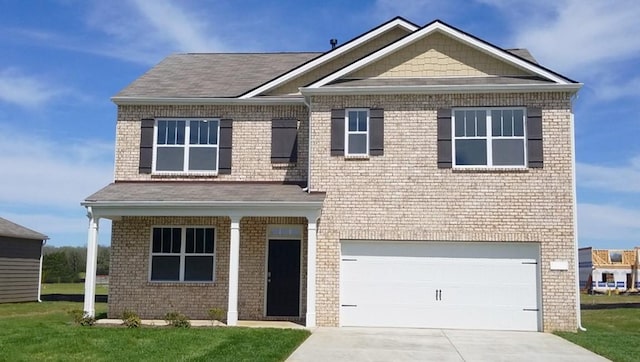 view of front of property with a garage and a front lawn