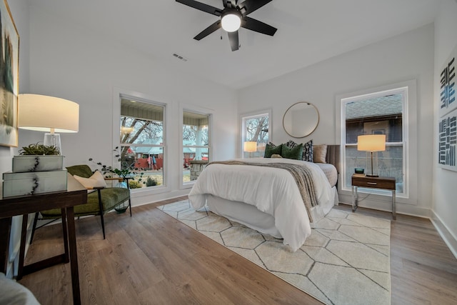 bedroom with ceiling fan and light wood-type flooring