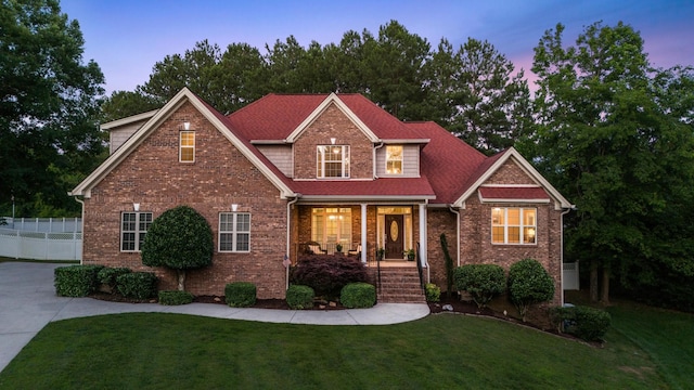 craftsman-style home with a yard