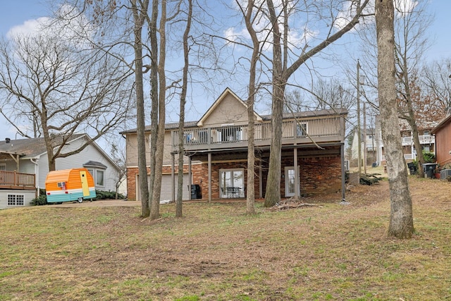 back of property featuring a wooden deck and a lawn