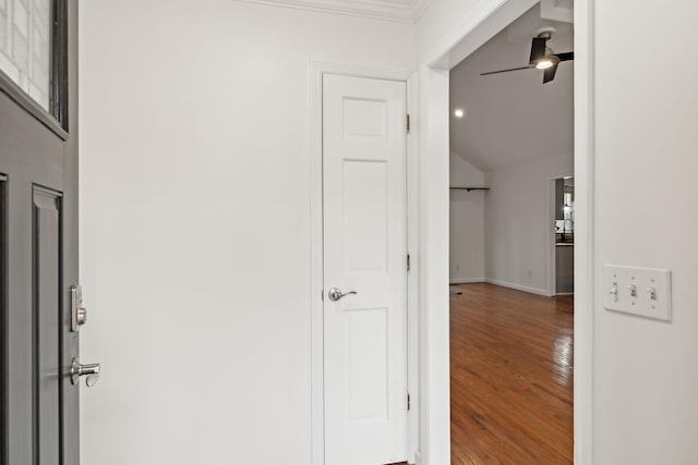 hall with lofted ceiling and hardwood / wood-style floors