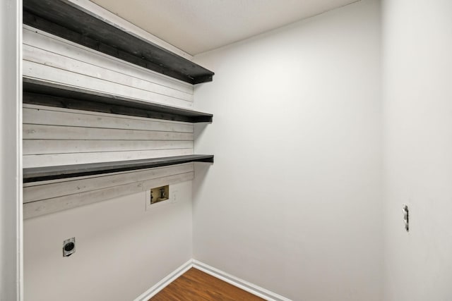 washroom with dark hardwood / wood-style flooring, hookup for a washing machine, and hookup for an electric dryer