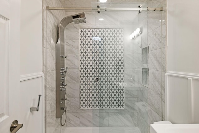 bathroom featuring a shower with shower door