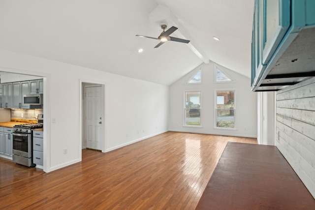 unfurnished living room with dark wood-type flooring, ceiling fan, beam ceiling, and high vaulted ceiling