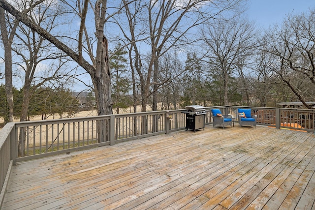 wooden deck featuring area for grilling