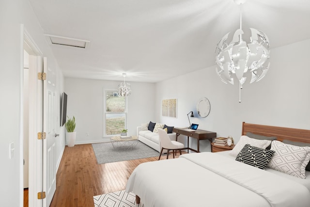 bedroom featuring hardwood / wood-style flooring and a notable chandelier