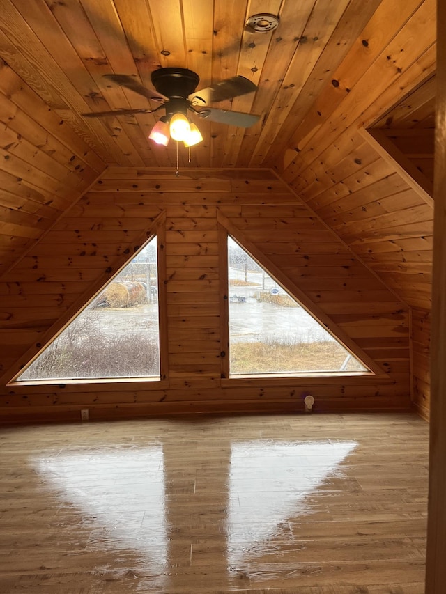 additional living space with vaulted ceiling, light wood-type flooring, ceiling fan, and wood ceiling