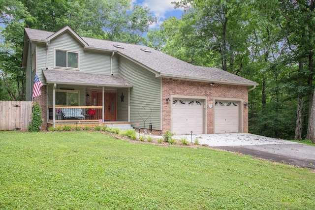 view of front of home featuring covered porch, a garage, and a front yard