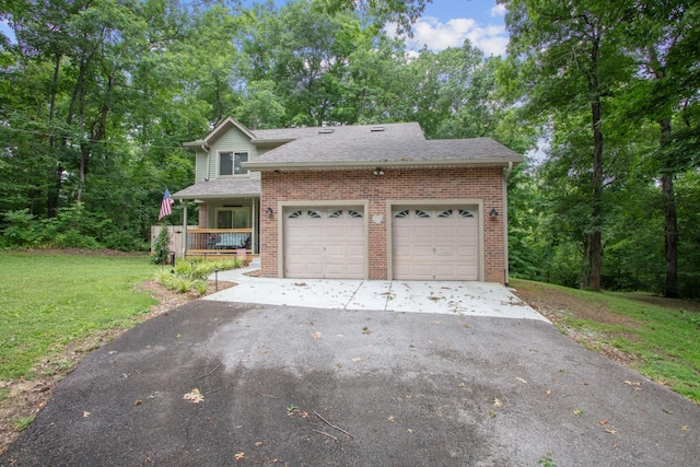 front of property featuring a garage, covered porch, and a front yard