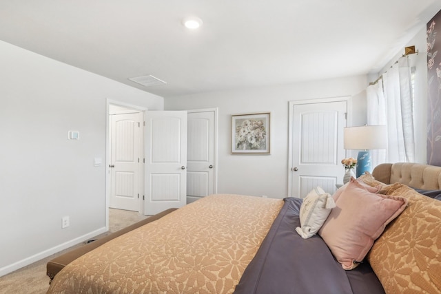 carpeted bedroom featuring visible vents and baseboards