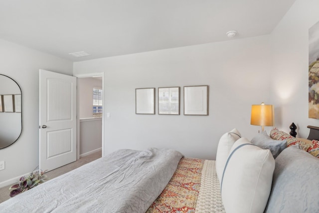 carpeted bedroom featuring baseboards