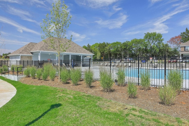 view of yard featuring a community pool and fence