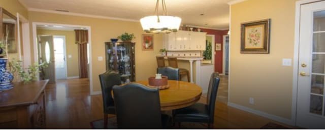 dining area featuring a chandelier and ornamental molding