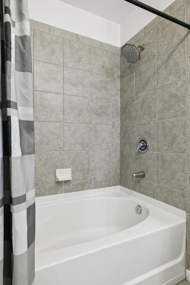 bathroom with shower / tub combo with curtain