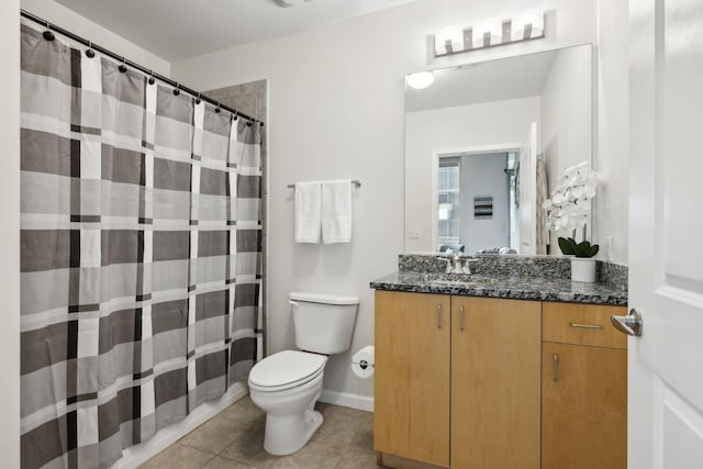 bathroom featuring tile patterned flooring, vanity, and toilet