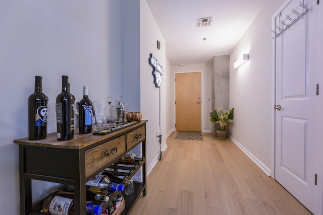 hall with light hardwood / wood-style flooring