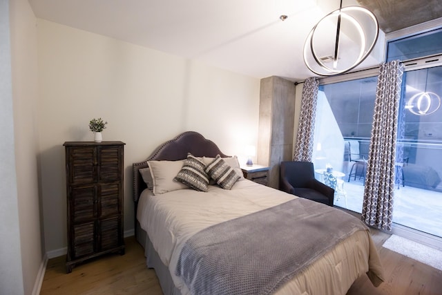 bedroom featuring access to exterior and light hardwood / wood-style flooring