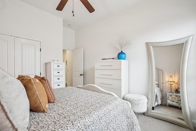 carpeted bedroom featuring ceiling fan and a closet