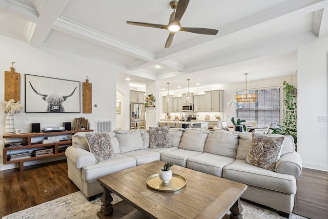 living room with beam ceiling, ceiling fan, dark wood-type flooring, and coffered ceiling