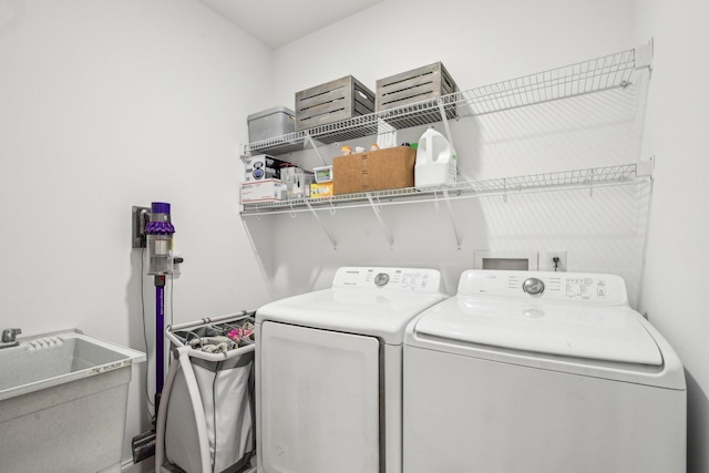 laundry room with washing machine and dryer and sink