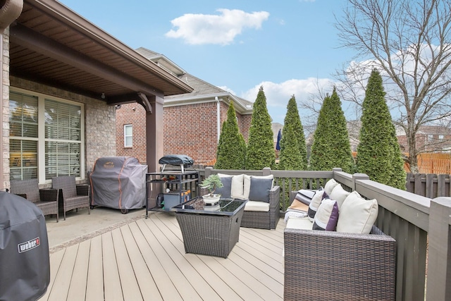 wooden deck with outdoor lounge area and a grill