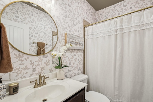 bathroom featuring vanity and toilet