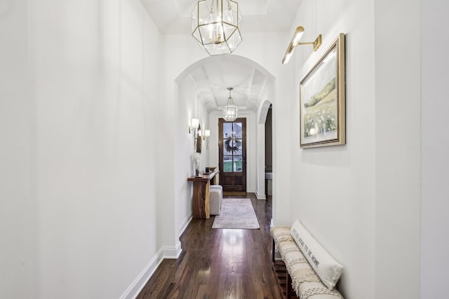 hallway featuring a chandelier and dark hardwood / wood-style floors