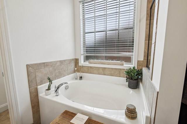 bathroom with a tub and a wealth of natural light