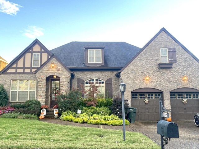 view of front of home with a garage and a front lawn