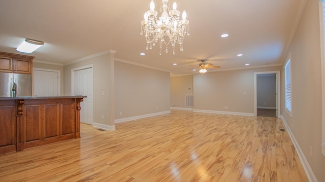 unfurnished living room featuring ceiling fan with notable chandelier, light wood-type flooring, and ornamental molding