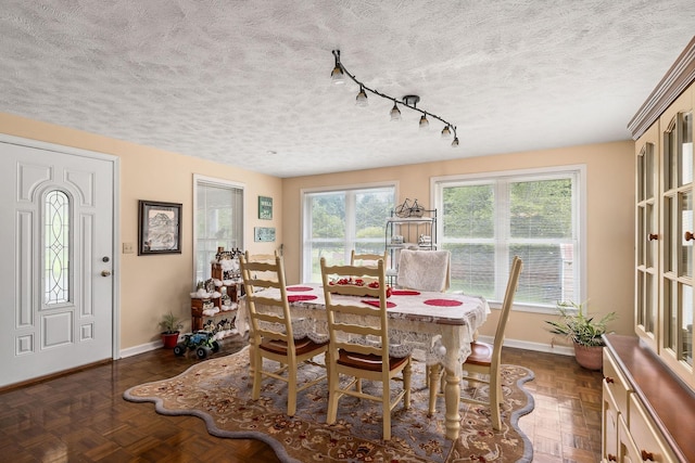 dining space with dark parquet flooring