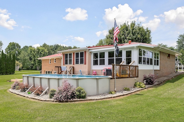 rear view of property featuring a yard