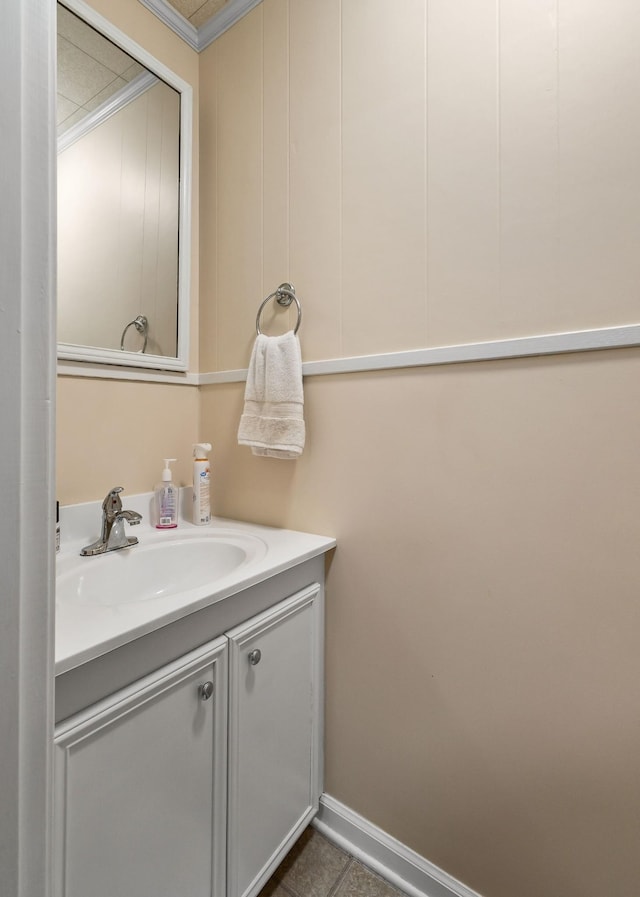 bathroom featuring crown molding, tile patterned flooring, and vanity