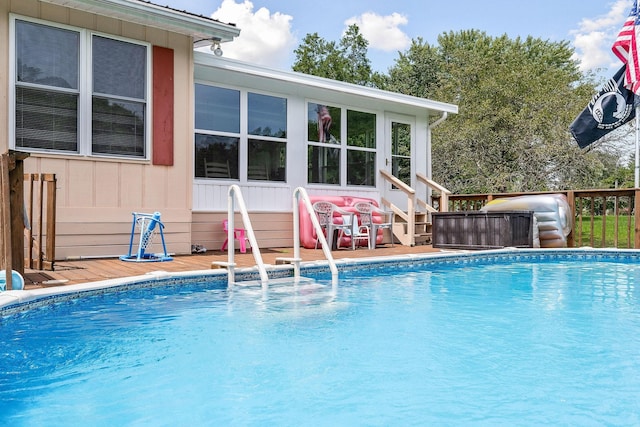 view of swimming pool with a wooden deck