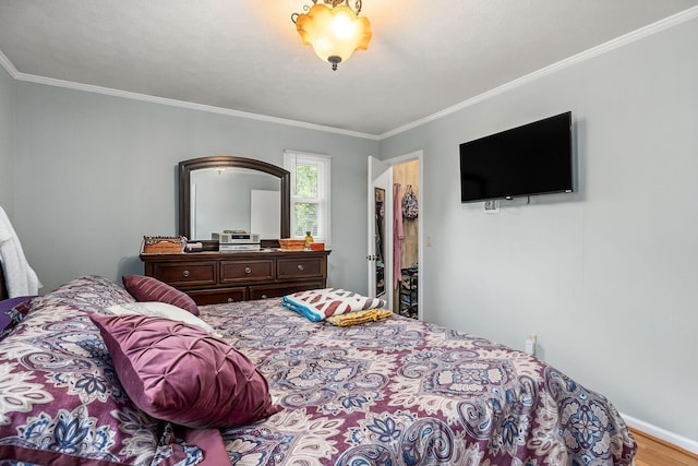 bedroom with crown molding and hardwood / wood-style flooring