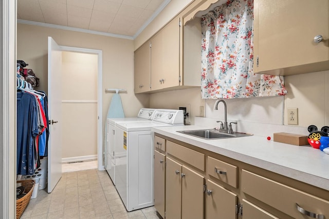 laundry room featuring washer and dryer, cabinets, sink, and crown molding