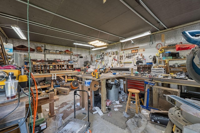 misc room with a workshop area and concrete flooring