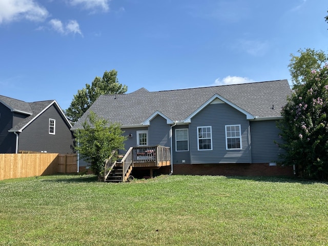 back of house featuring a lawn and a deck