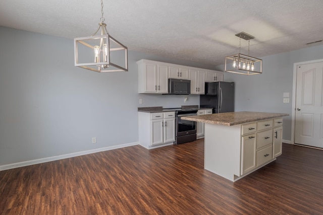 kitchen with dark wood-type flooring, black appliances, a kitchen island, pendant lighting, and white cabinets