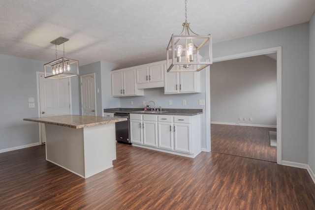 kitchen with white cabinetry, decorative light fixtures, and dishwasher