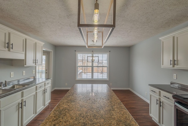 kitchen with pendant lighting, white cabinets, and dark hardwood / wood-style flooring