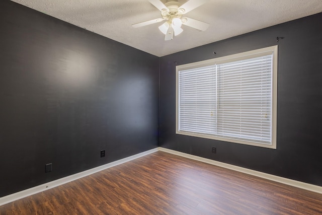 unfurnished room with ceiling fan, dark hardwood / wood-style flooring, and a textured ceiling