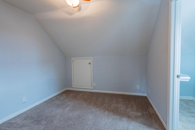 bonus room with carpet floors and vaulted ceiling