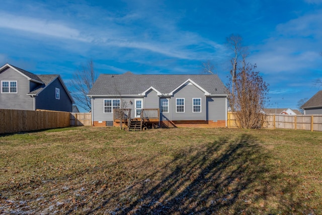 back of property with a yard and a deck