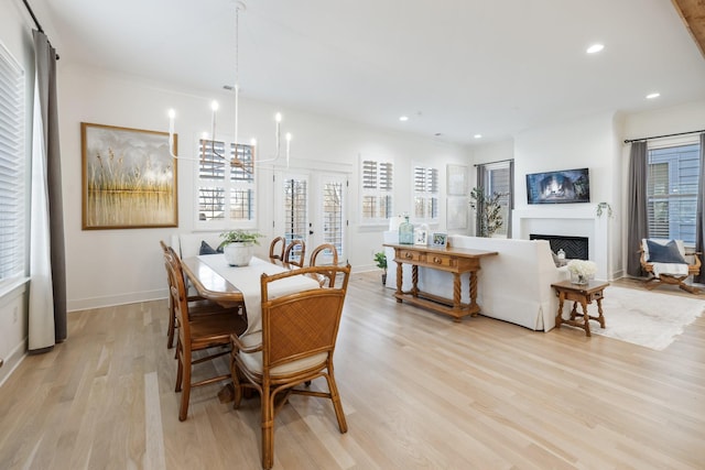 dining room featuring light hardwood / wood-style flooring and a notable chandelier