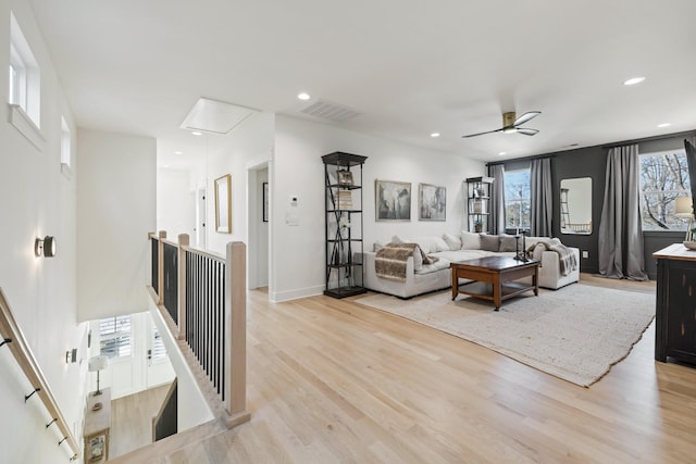 living room featuring ceiling fan and light wood-type flooring