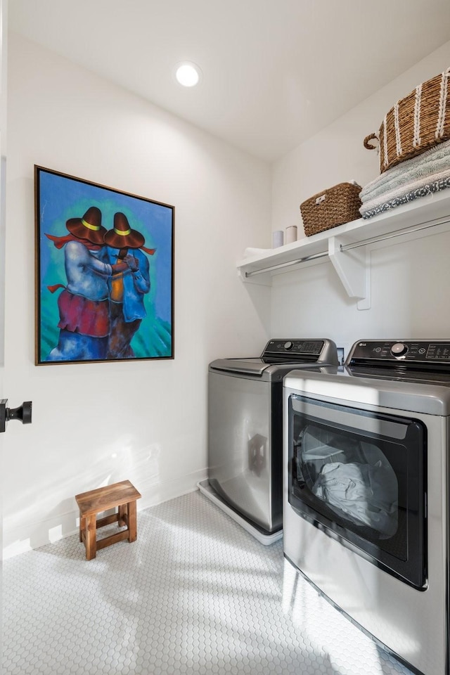 washroom with washing machine and clothes dryer and carpet