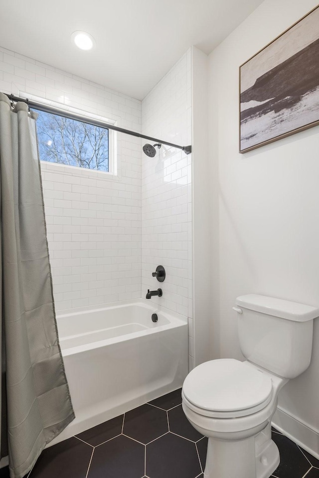 bathroom featuring tile patterned floors, toilet, and shower / tub combo with curtain