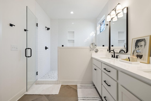 bathroom with tile patterned flooring, vanity, and a shower with shower door