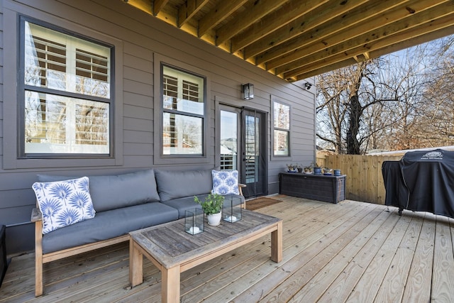 wooden deck with outdoor lounge area and grilling area